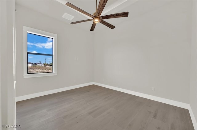 unfurnished room with visible vents, ceiling fan, baseboards, and wood finished floors