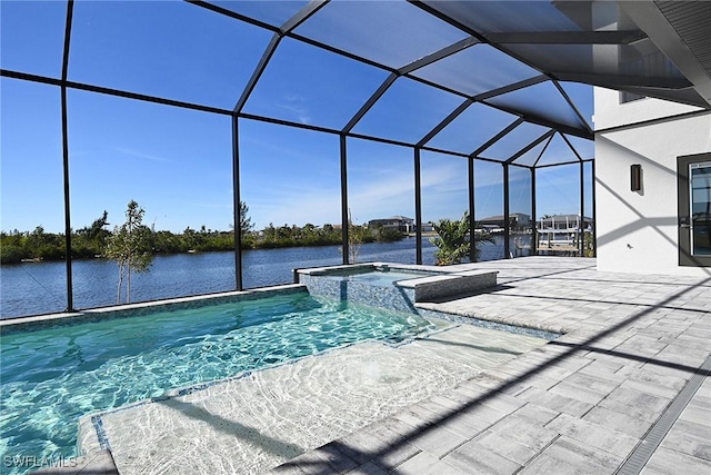 view of pool with an in ground hot tub, a water view, glass enclosure, and a patio area