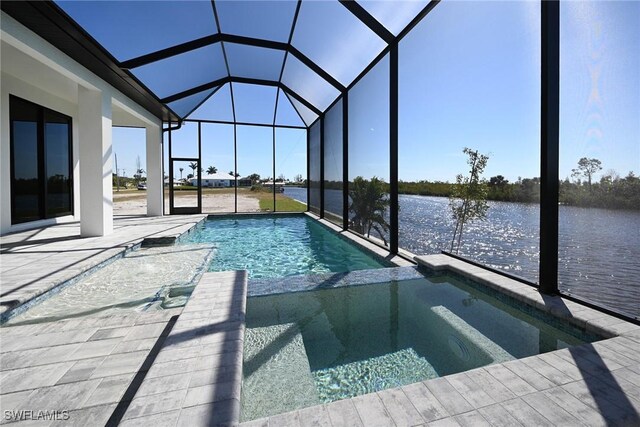 view of pool with a patio, a water view, a lanai, and a pool with connected hot tub