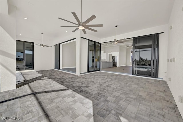 unfurnished living room with ceiling fan