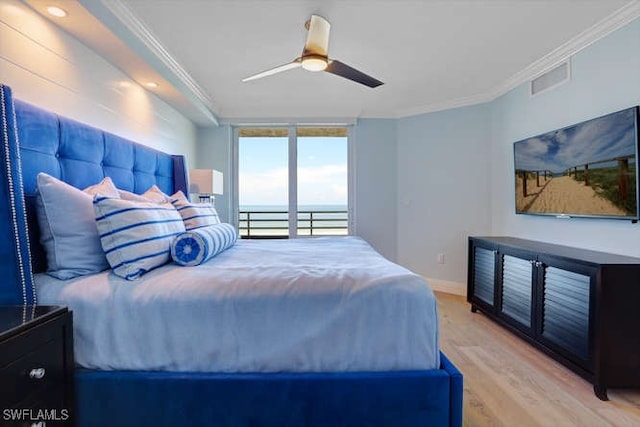 bedroom featuring floor to ceiling windows, light wood-type flooring, ceiling fan, and ornamental molding