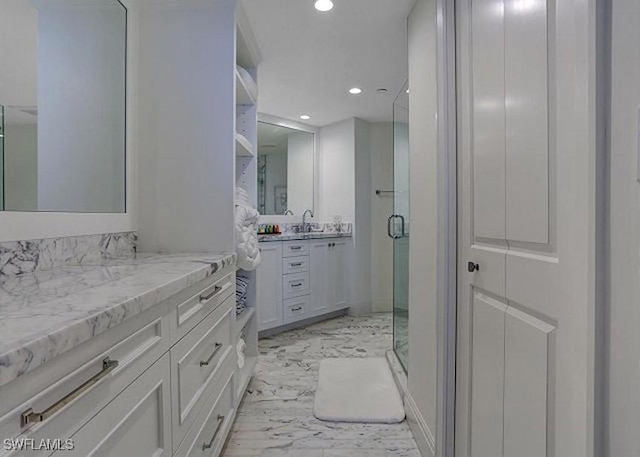 bathroom with vanity and a shower with shower door