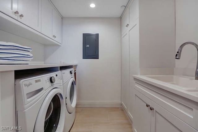 washroom featuring washing machine and clothes dryer, sink, cabinets, electric panel, and light tile patterned floors