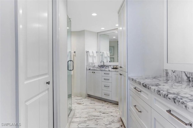 bathroom featuring vanity and an enclosed shower