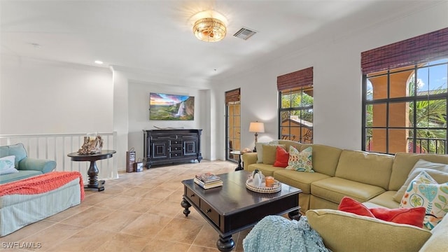 living room featuring light tile patterned floors and crown molding