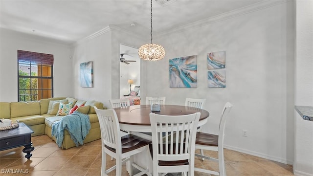 tiled dining area with ceiling fan and ornamental molding