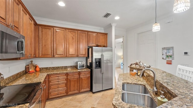 kitchen featuring light stone countertops, appliances with stainless steel finishes, crown molding, sink, and decorative light fixtures