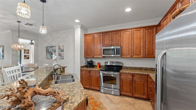 kitchen featuring appliances with stainless steel finishes, light stone counters, crown molding, sink, and hanging light fixtures