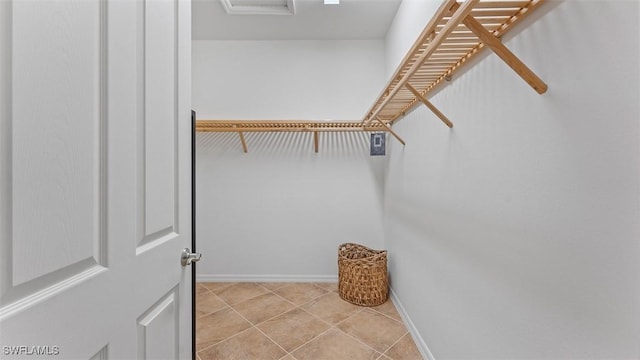 walk in closet with light tile patterned flooring