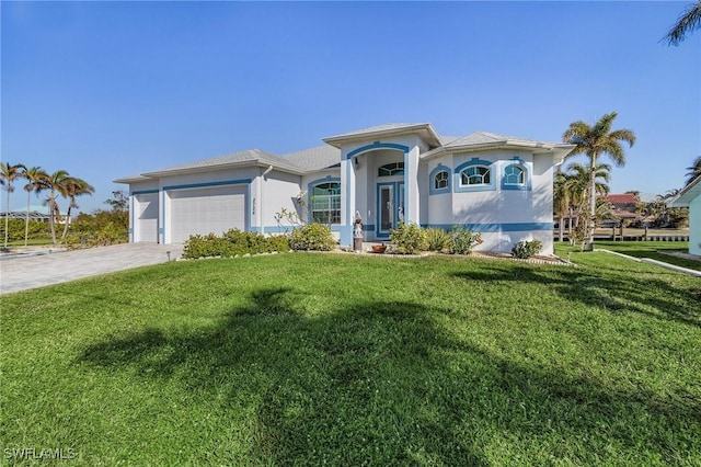 view of front of property featuring a front yard and a garage