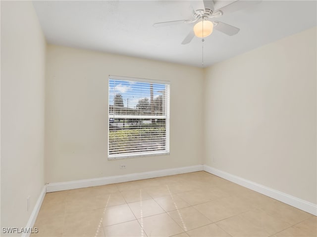 unfurnished room featuring light tile patterned floors and ceiling fan