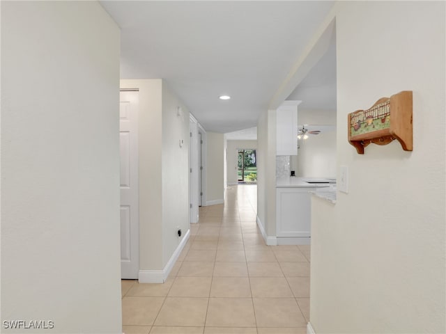 corridor featuring light tile patterned floors