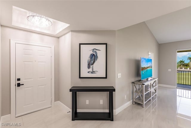 interior space featuring lofted ceiling and a notable chandelier