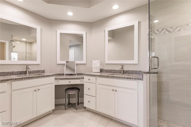 bathroom featuring tile patterned flooring, vanity, and walk in shower