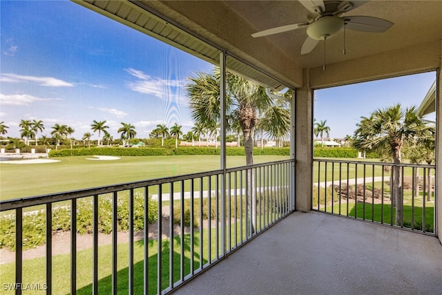 unfurnished sunroom featuring ceiling fan