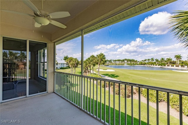 balcony with a water view and ceiling fan