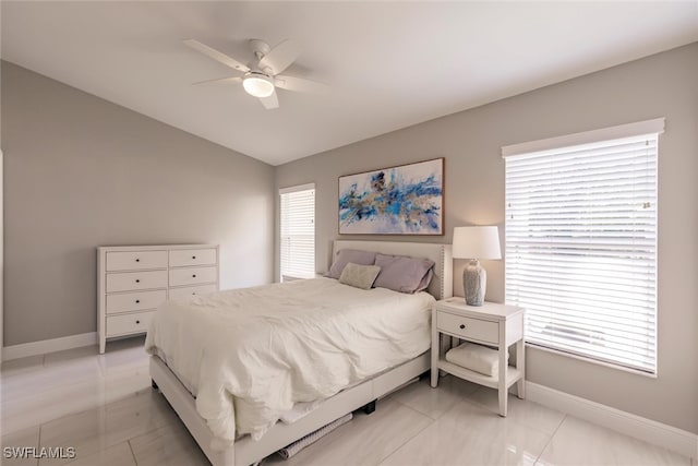 bedroom featuring light tile patterned floors, multiple windows, and ceiling fan