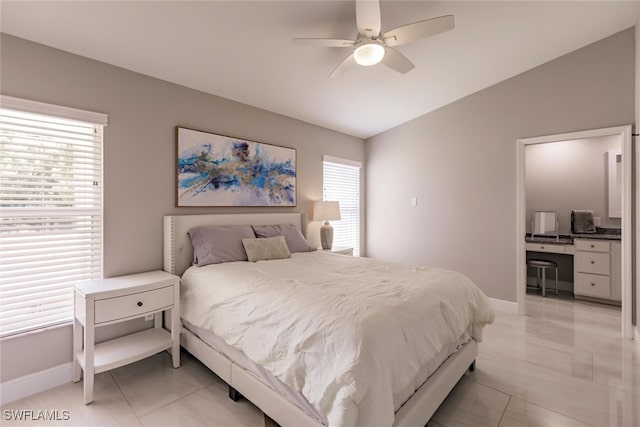 bedroom with ceiling fan, light tile patterned floors, and vaulted ceiling