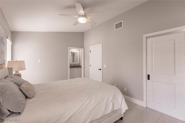 bedroom with ceiling fan, light tile patterned flooring, lofted ceiling, and ensuite bathroom