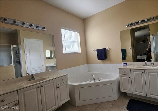 bathroom with tile patterned flooring, vanity, and shower with separate bathtub