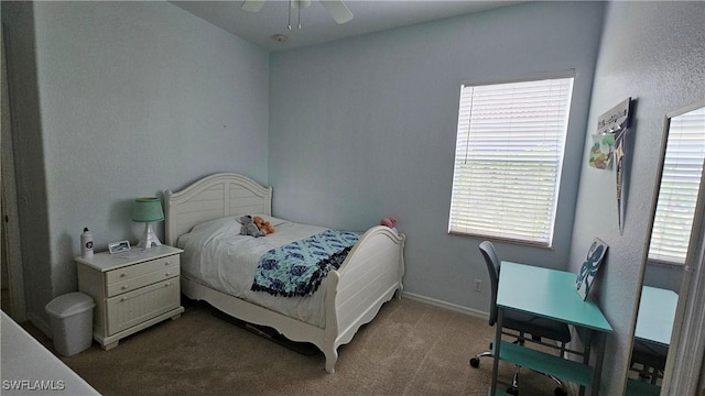 carpeted bedroom with ceiling fan and multiple windows