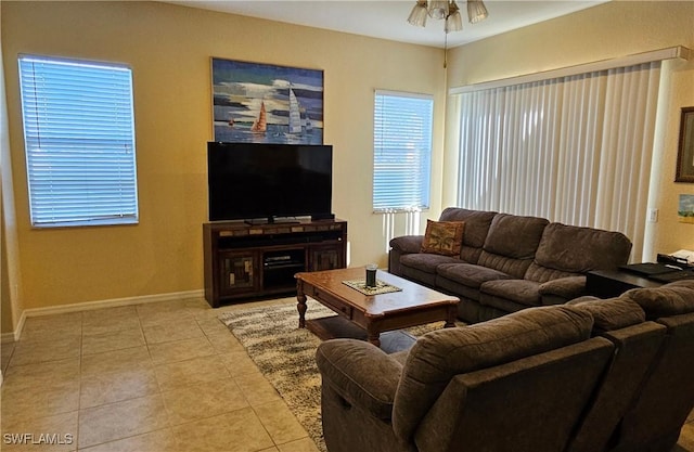 tiled living room with ceiling fan