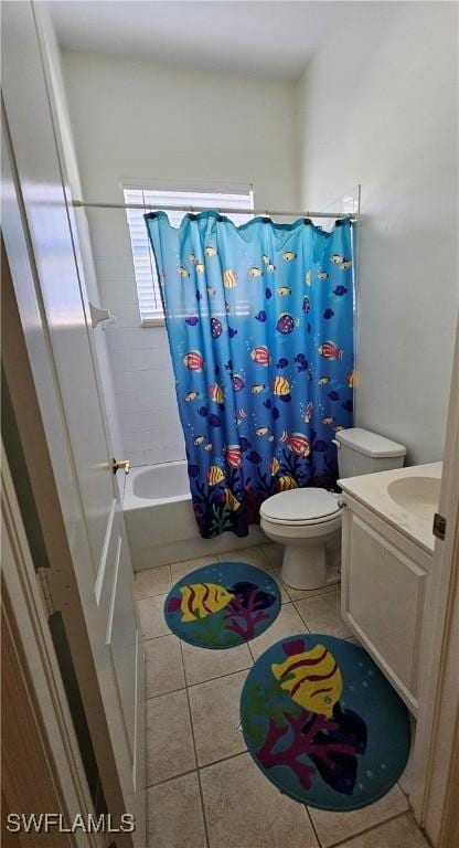 full bathroom featuring toilet, shower / tub combo, vanity, and tile patterned floors