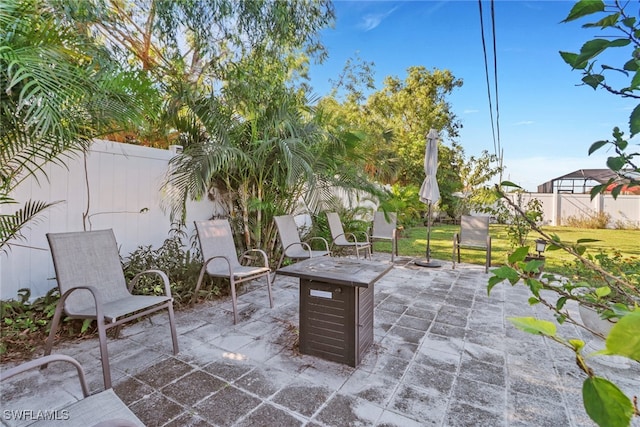 view of patio with a fire pit