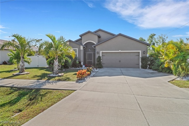 view of front facade featuring a front yard and a garage