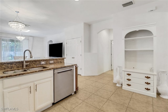 kitchen with dishwasher, sink, dark stone countertops, decorative light fixtures, and white cabinets