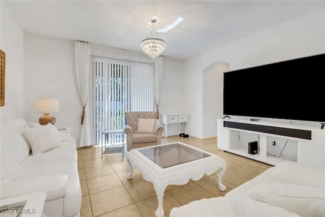 tiled living room featuring an inviting chandelier