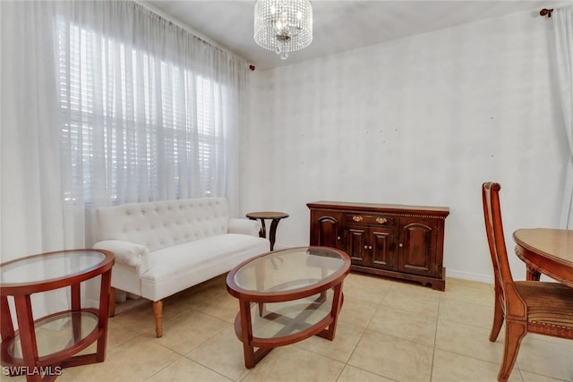 sitting room featuring a chandelier and light tile patterned floors