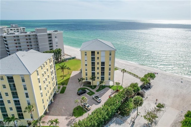 bird's eye view featuring a water view and a beach view