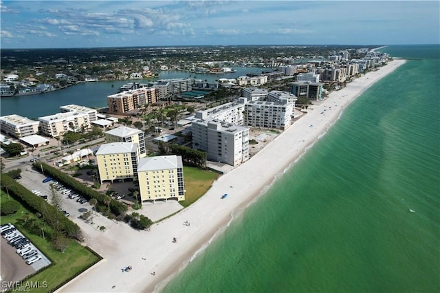 birds eye view of property featuring a water view and a beach view