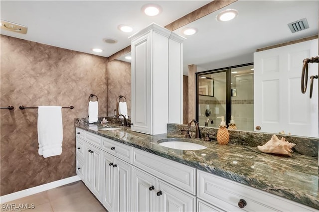 bathroom with tile patterned flooring, vanity, and an enclosed shower