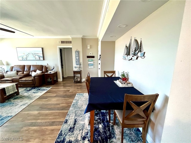 dining area with hardwood / wood-style floors and ornamental molding