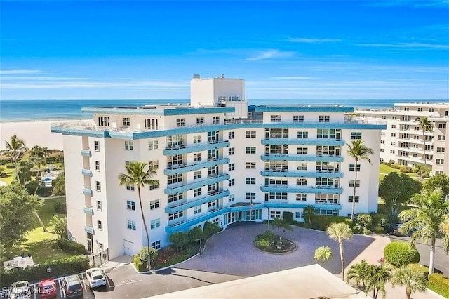 view of property featuring a water view and a view of the beach