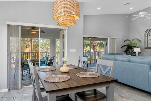 dining space featuring ceiling fan and high vaulted ceiling