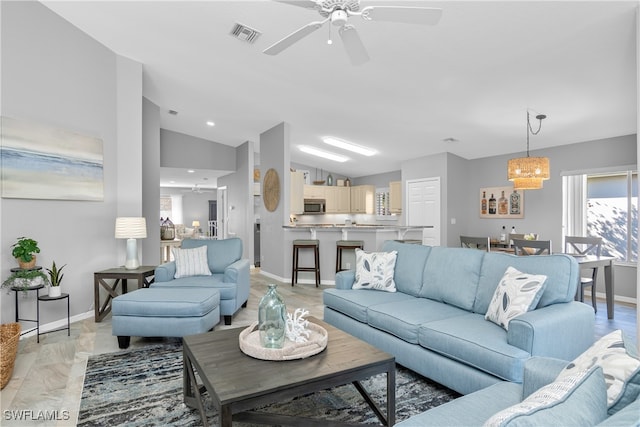 living room featuring vaulted ceiling and ceiling fan