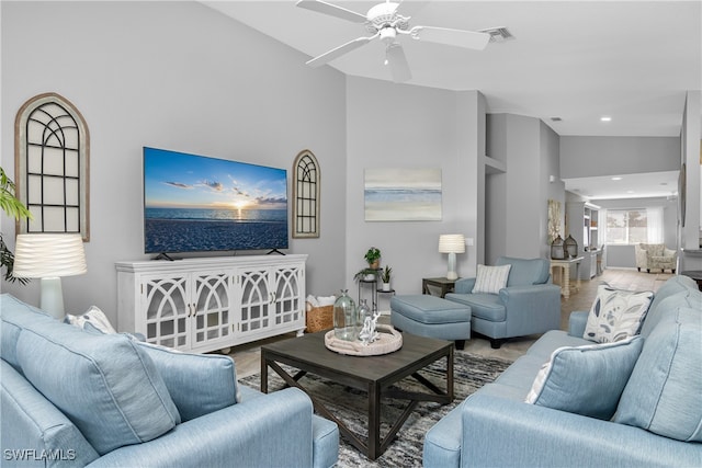 living room featuring ceiling fan and high vaulted ceiling