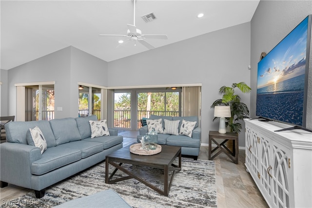 living room with ceiling fan, a healthy amount of sunlight, and high vaulted ceiling