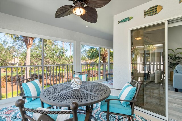 sunroom / solarium featuring ceiling fan