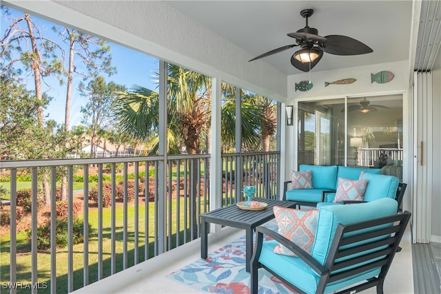 sunroom featuring ceiling fan