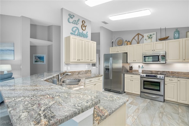 kitchen with kitchen peninsula, light stone countertops, sink, and stainless steel appliances