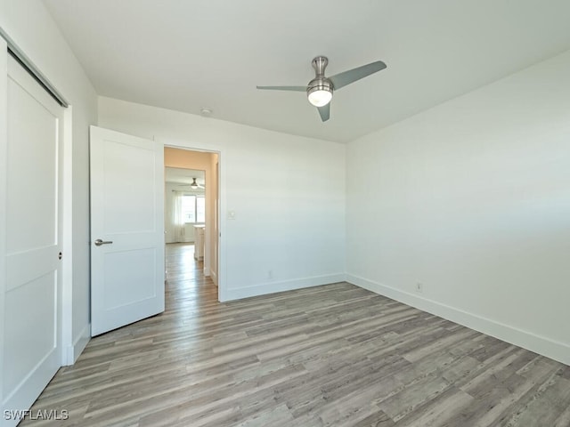 spare room with ceiling fan and light hardwood / wood-style floors