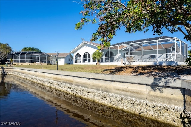 2711 W Marion Ave, Punta Gorda, FL 33950 - back of house with a lanai, a lawn, and a water view