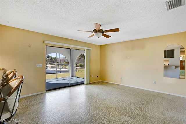 spare room featuring ceiling fan and a textured ceiling