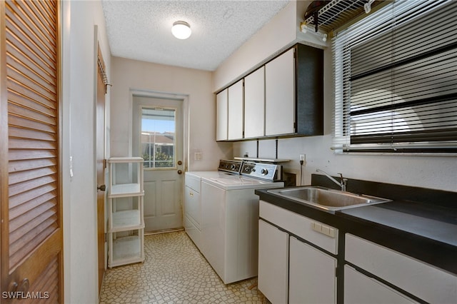 2711 W Marion Ave, Punta Gorda, FL 33950 - laundry room featuring separate washer and dryer, cabinet space, light flooring, and a textured ceiling