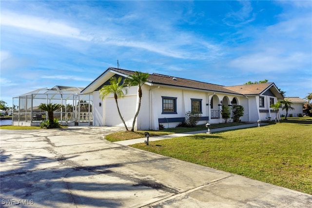 view of front of house featuring glass enclosure, a garage, and a front lawn