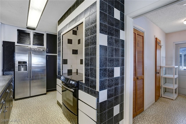 kitchen with wall oven, light tile patterned flooring, stainless steel fridge with ice dispenser, and a textured ceiling